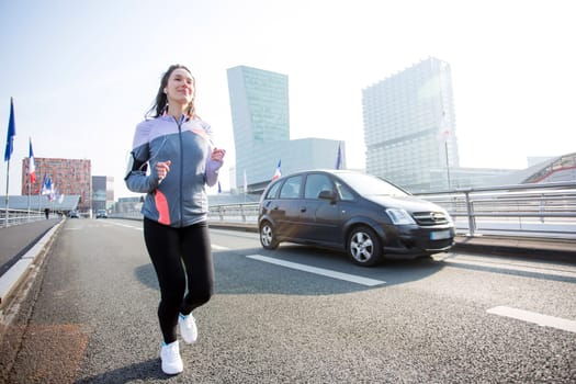 View of a Young attractive woman running downtown
