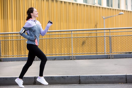 View of a Young attractive woman running downtown