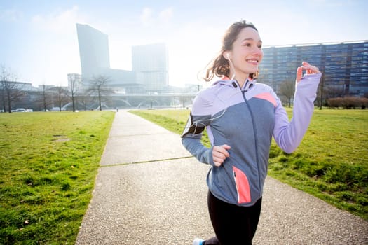 View of a Young attractive woman running at the park