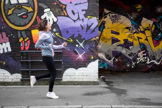 View of a Young attractive woman running downtown