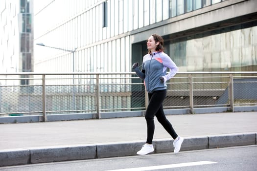 View of a Young attractive woman running downtown