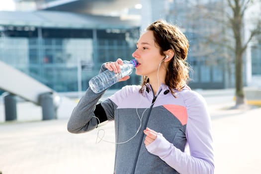 View of a Woman drinking water during a running session