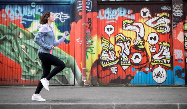 View of a Young attractive woman running downtown