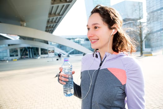 View of a Woman drinking water during a running session