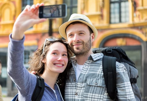 View of a Young couple on holidays taking selfie