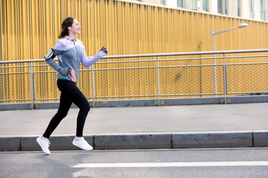 View of a Young attractive woman running downtown
