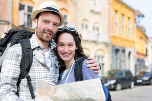 View of a Couple of young attractive tourists watching map