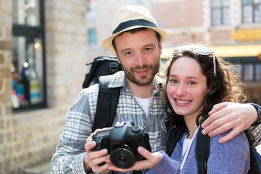 View of Young couple of tourist watching photographs on camera