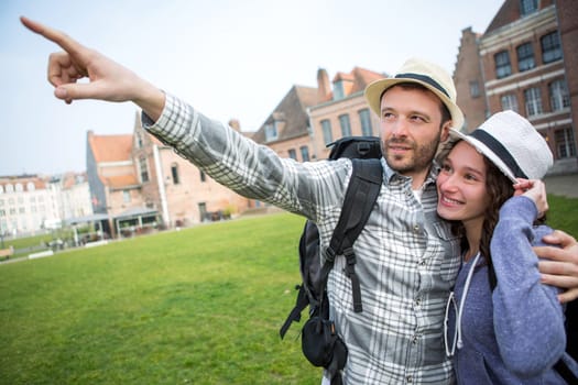 View of a Couple of young attractive tourists discovering city