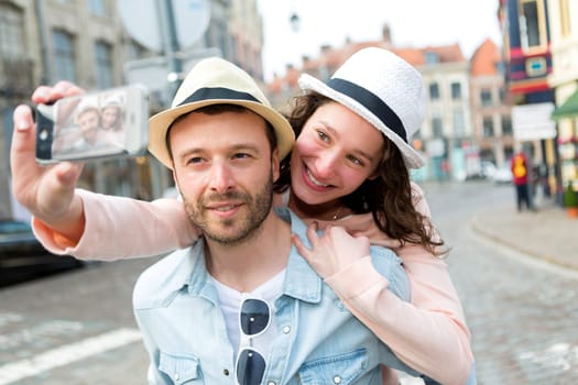 View of a Young couple on holidays taking selfie