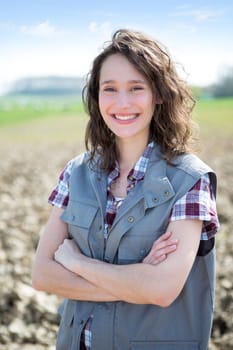 View of a young attractive farmer in fields