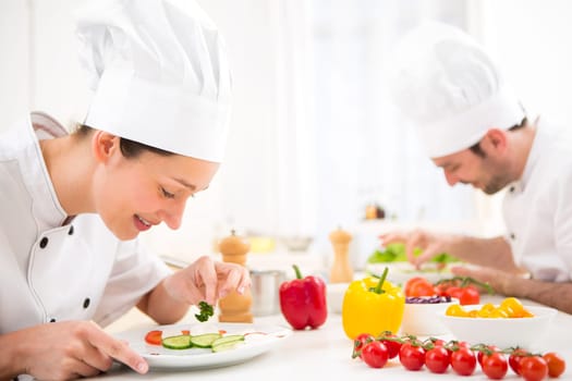 View of a Young attractive professional chef cooking in his kitchen