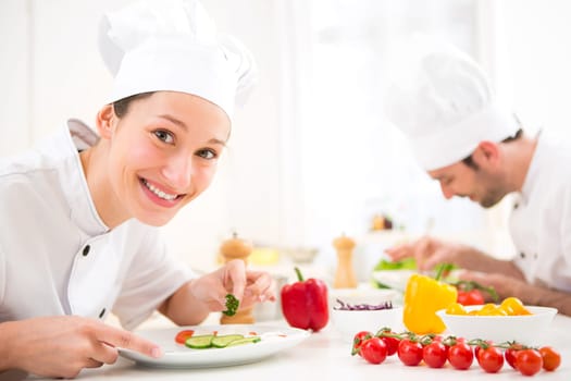View of a Young attractive professional chef cooking in his kitchen