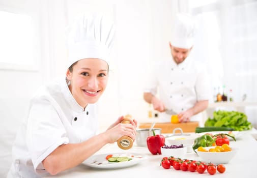 View of a Young attractive professional chef cooking in his kitchen