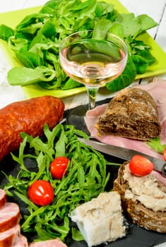 charcuterie plate with wine bread and tomatoes
