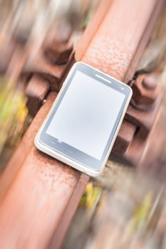 Travel on the tracks of the technology. Smartphone on rail like a metaphor.