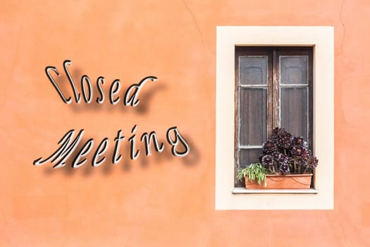 Closed window with planter  and orange wall, with written "Closed Meeting"""