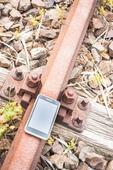 Travel on the tracks of the technology. Smartphone on rail like a metaphor.