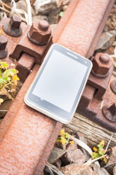 Travel on the tracks of the technology. Smartphone on rail like a metaphor.