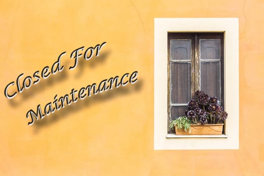 Closed window with planter  and yellow wall with written "closed For Maintenance"""