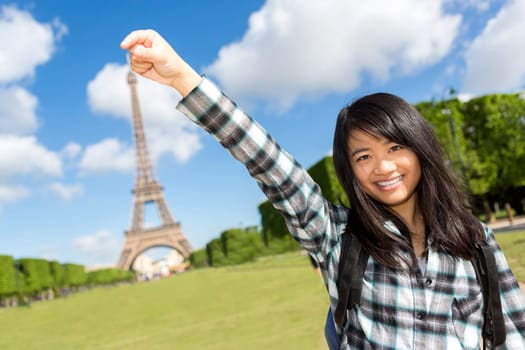 View of a Young attractive asian tourist in front of Eiffel tower