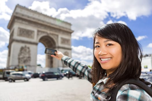 View of a Young attractive asian tourist taking pictures in Paris
