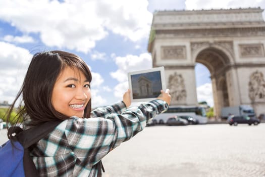 View of a Young attractive asian tourist taking pictures in Paris