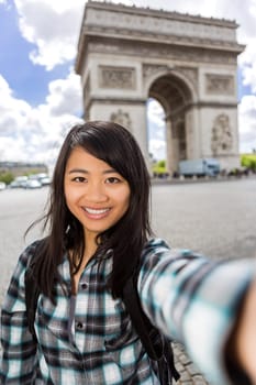 View of a Young attractive asian tourist in Paris taking selfie