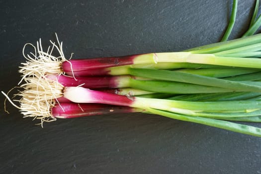 Fresh red Spring Onions on a cutting board