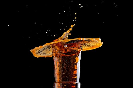 Beer splash in glass  on black background