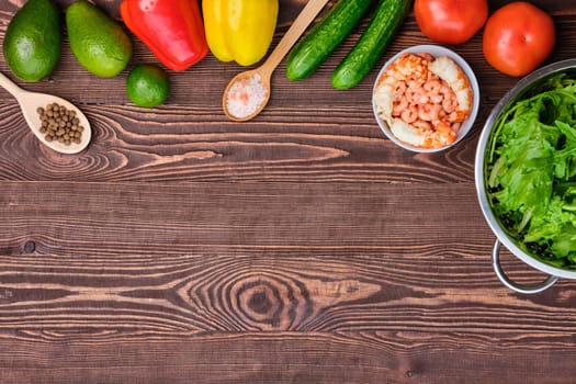 Fresh vegetables and spices on wooden table, view from above, place for text