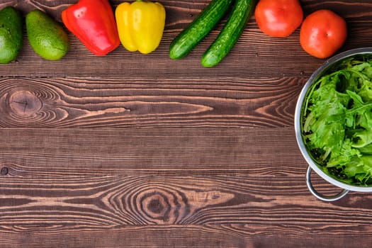 Fresh vegetables on wooden table, view from above, place for text