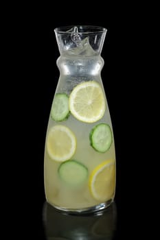 Decanter with lemon and cucumber lemonade isolated on black