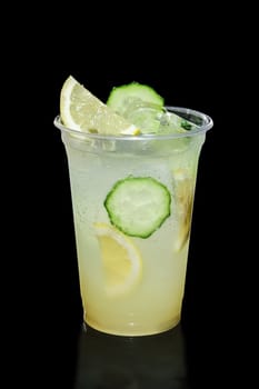 Take away glass with lemon and cucumber lemonade isolated on black