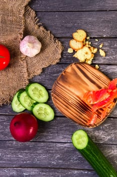 Fresh vegetables on wooden board with a napkin on a table.