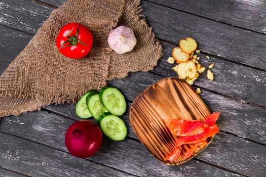 Fresh vegetables on wooden board with a napkin on a table.