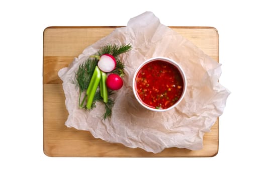 Top view of plate with celery and radish soup isolated on white
