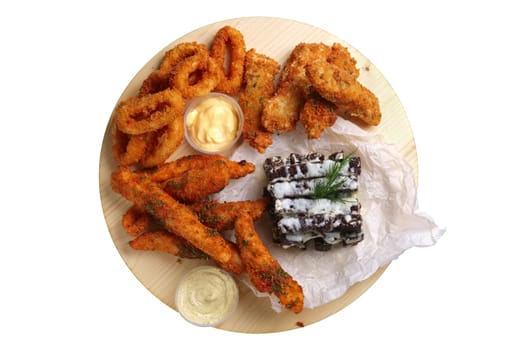 Big set of snack for beer with onion rings and carrot in breading, chicken wings, garlic brown bread