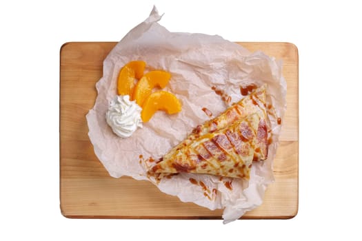 Thin pancakes stuffed with apricot and soft cheese isolated on white