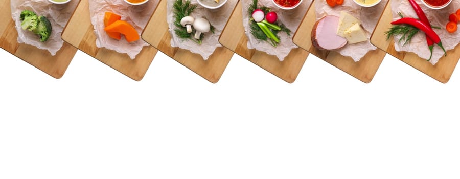 Variety of colorful vegetables and ingredients for cream soups top view isolated on white