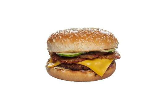 Bun with sesame with cutlet, cheese, bacon and cucumber inside isolated on white background