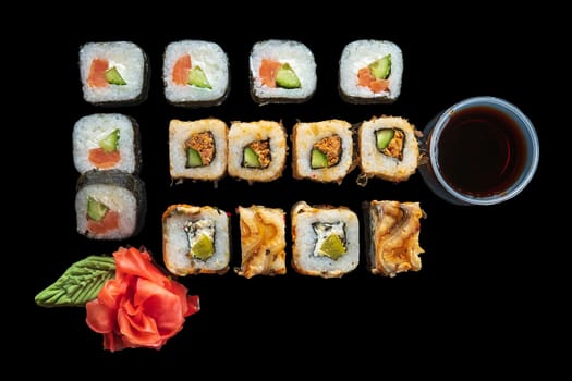 Top view of big set of rolls on black background
