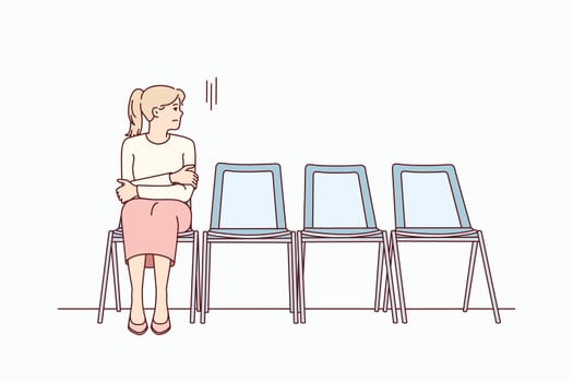 Anxious young woman sit on chair in corridor waiting or appointment. Stressed female feel worried wait in line in hallway. Vector illustration.