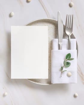 Elegant Table setting with card and envelope decorated with eucalyptus branches top view, Wedding Mockup. Romantic table with vertical paper card. Close to nature and simplicity concepts