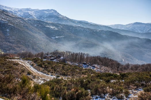 Fog ambient between snowy peaks of the Sierra de Gredos. La Garganta, Ambroz Valley, Extremadura, Caceres, Spain