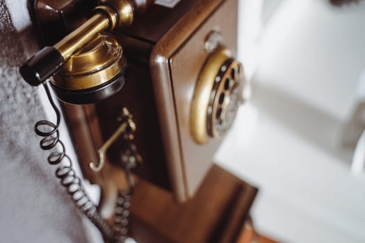 top view closeup of vintage brown wooden phone on wall