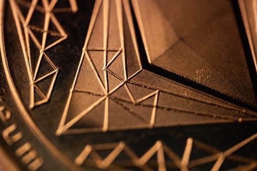 top view extreme macro closeup of crypto ethereum golden coin geometric symbol logo
