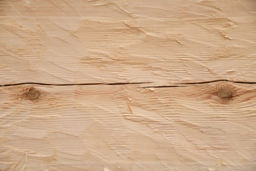 Close-up of the beveled pine wood in the raw state as a background. The pine is a softwood. The wood is coated with linseed oil balsam turpentine and thus made more durable.