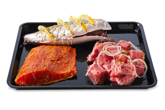 Marinated varieties of meat and fish ready for grilling isolated on white background