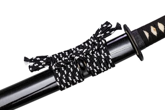 Close up shot of Sageo - Thick black-white silk rope for tying the scabbard of Japanese swords. It was a rope for the samurai to tie at the waist. isolated on white background. Selective focus.